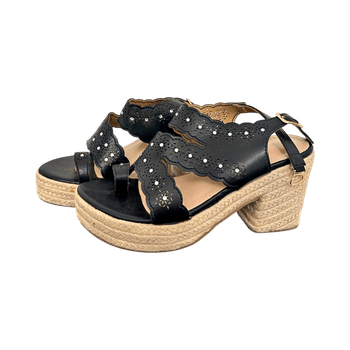 a pair of black wedge platform sandals with cutout accents and rhinestones