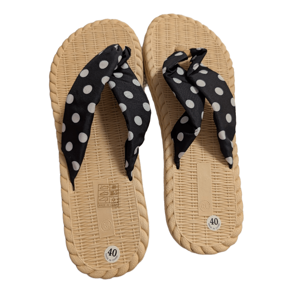 Black polka dot flip flops