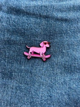 Pink skateboard tax dog pin