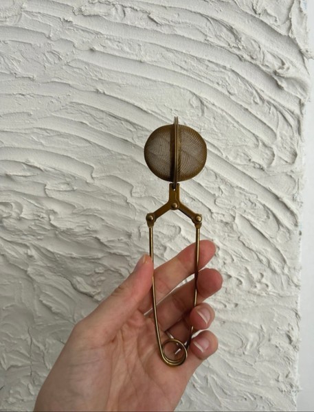 Gold tone tea infuser