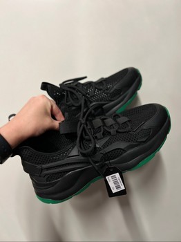 Black sneakers with green soles