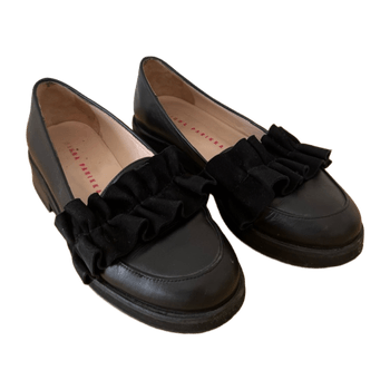 Black loafers with ruffle detail