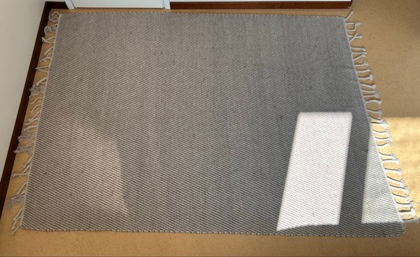 Grey woven fringe rug