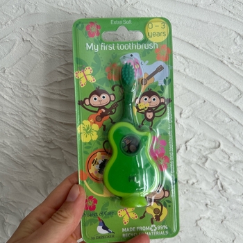 Green baby toothbrush guitar shape