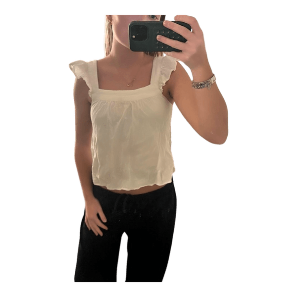 White ruffled sleeveless top