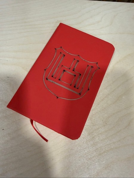 Red notebook with emblem