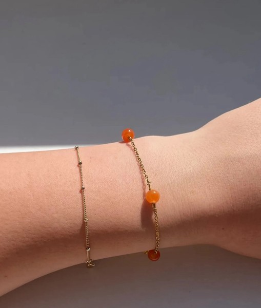 Guldfarvet armbånd med orange perler