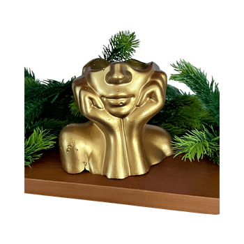 Golden face sculpture