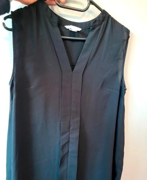 Black sleeveless blouse.