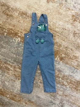 Blue denim overalls with dinosaur