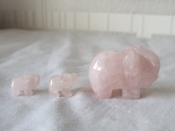 3 elephant statues made of rose quartz